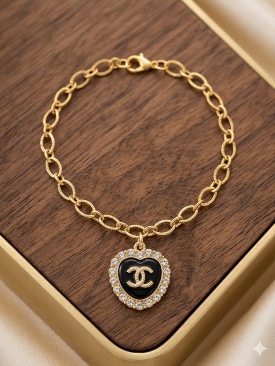 Chanel. Jewelry - ChaneI Black Heart 🖤 Pendant Charm Gold Tone Bracelet with Crystal Halo